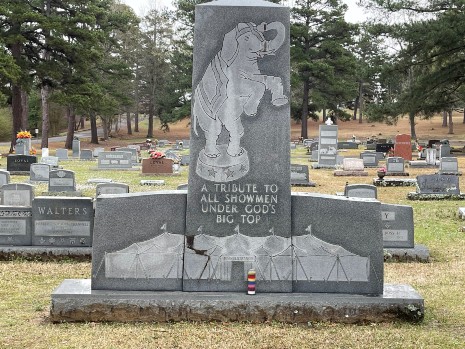 Granite memorial signifying section of cemetery reserved for circus performers and rodeo cowboys.